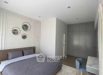 Spacious modern bedroom with elegant decor and built-in wardrobe