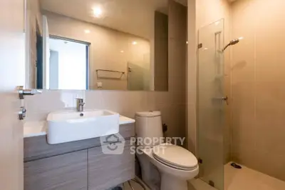 Modern bathroom with sleek fixtures and glass shower enclosure