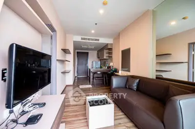 Modern living room with sleek furniture and open kitchen layout in a stylish apartment.