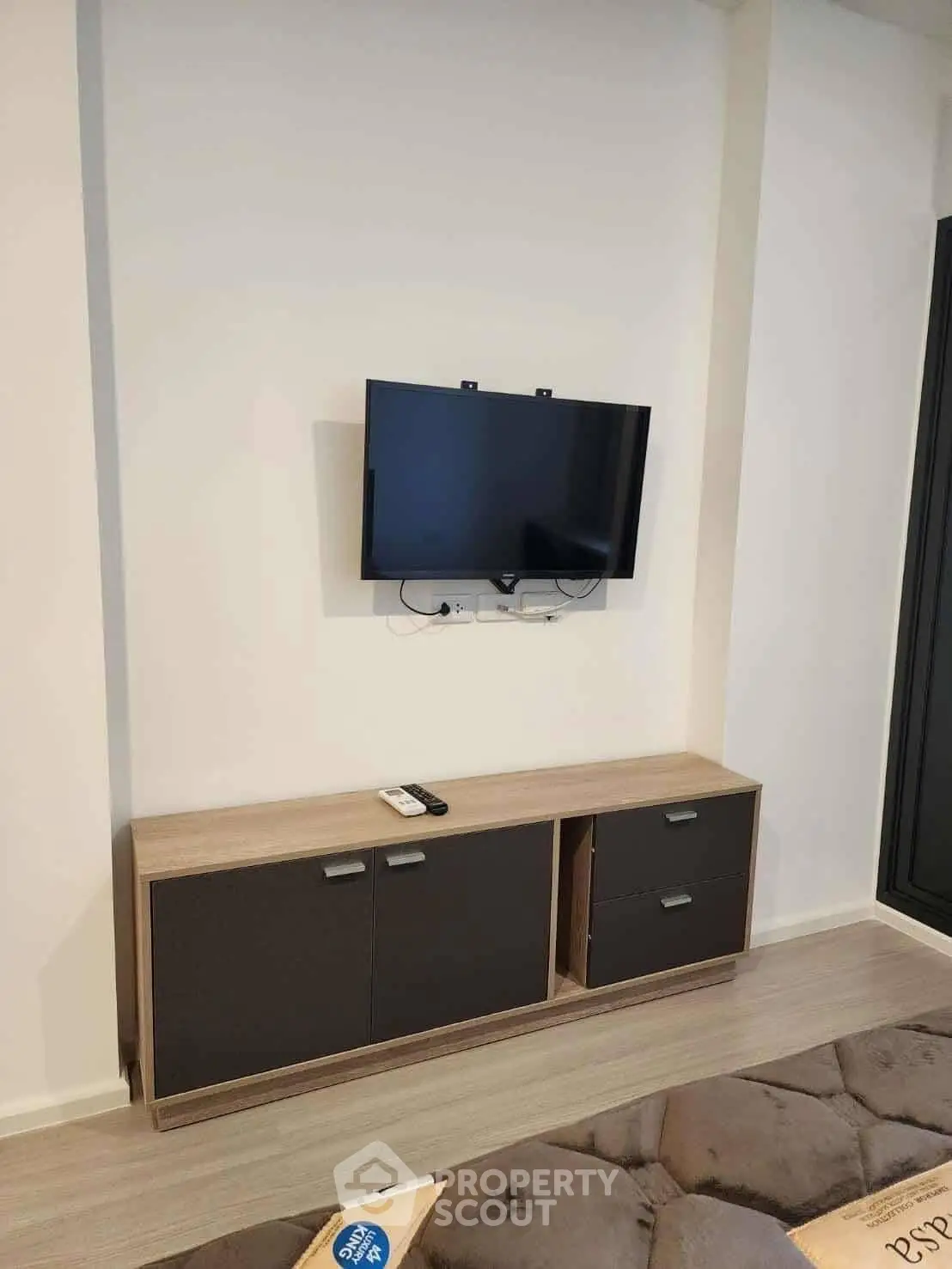 Modern living room with wall-mounted TV and sleek cabinet