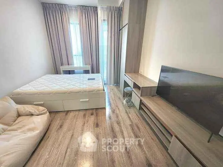 Modern bedroom with sleek wooden flooring and stylish furniture