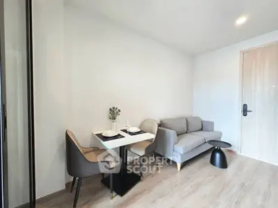 Modern living room with cozy sofa and dining area in a stylish apartment.