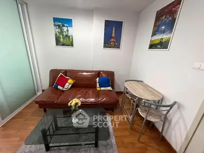 Charming living room with modern decor and cozy seating in a stylish apartment.