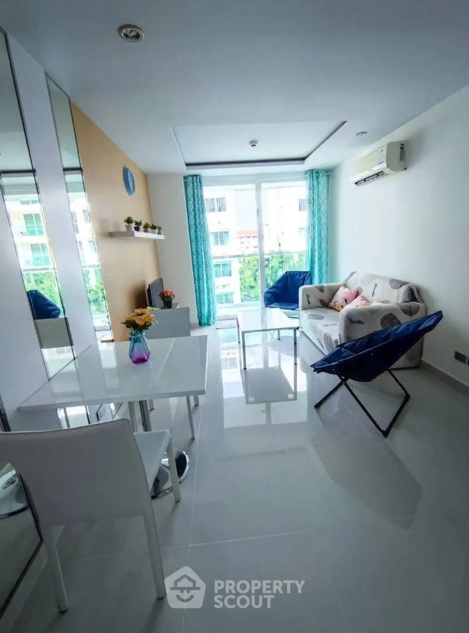 Bright modern living room with large windows and stylish furniture in a high-rise apartment.