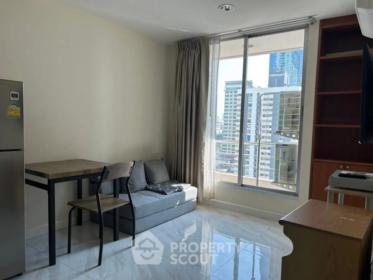 Modern living room with city view, featuring sleek furniture and large windows for natural light.