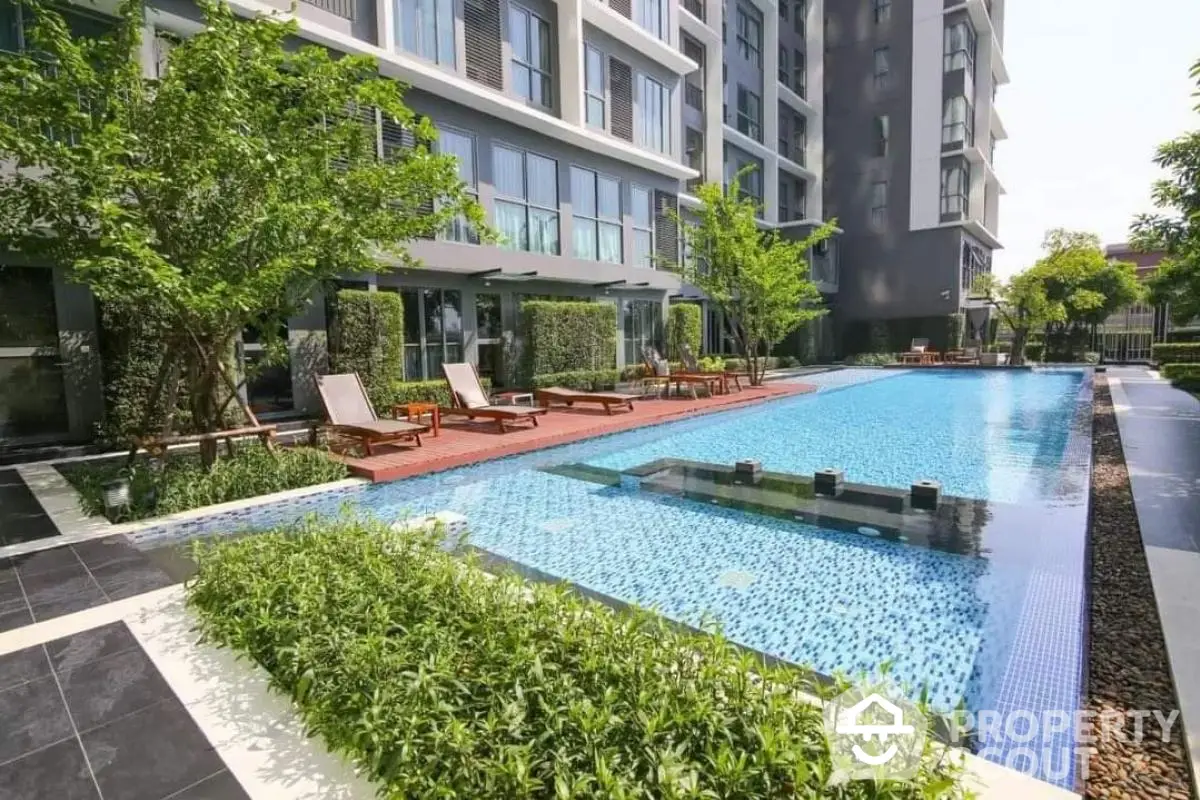 Luxurious apartment complex with stunning pool and lush greenery