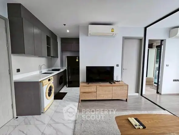 Modern open-plan living room with sleek kitchen and stylish furniture