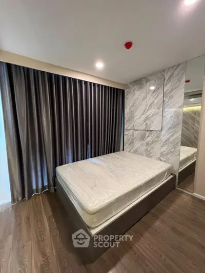 Modern bedroom with elegant marble wall and floor-to-ceiling curtains