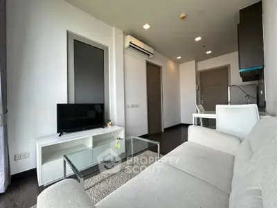 Modern living room with sleek furniture and natural light in a stylish apartment.