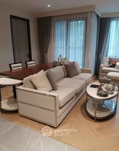 Elegant living room with modern furniture and natural light, perfect for relaxation and entertaining.