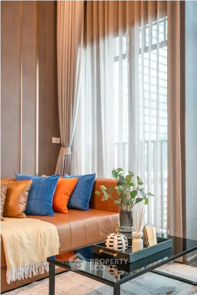 Stylish living room with modern decor and large windows for natural light.