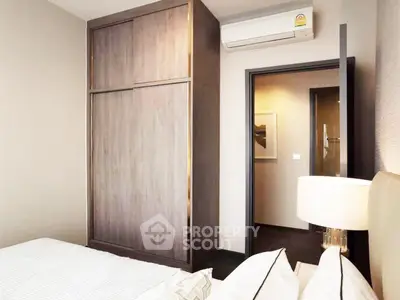 Modern bedroom with sleek wardrobe and air conditioning unit, perfect for comfortable living.