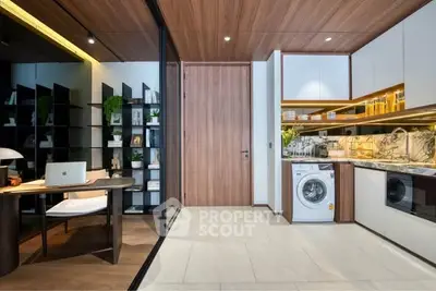 Modern kitchen with sleek appliances and adjacent study area, featuring elegant wood finishes and ample storage.