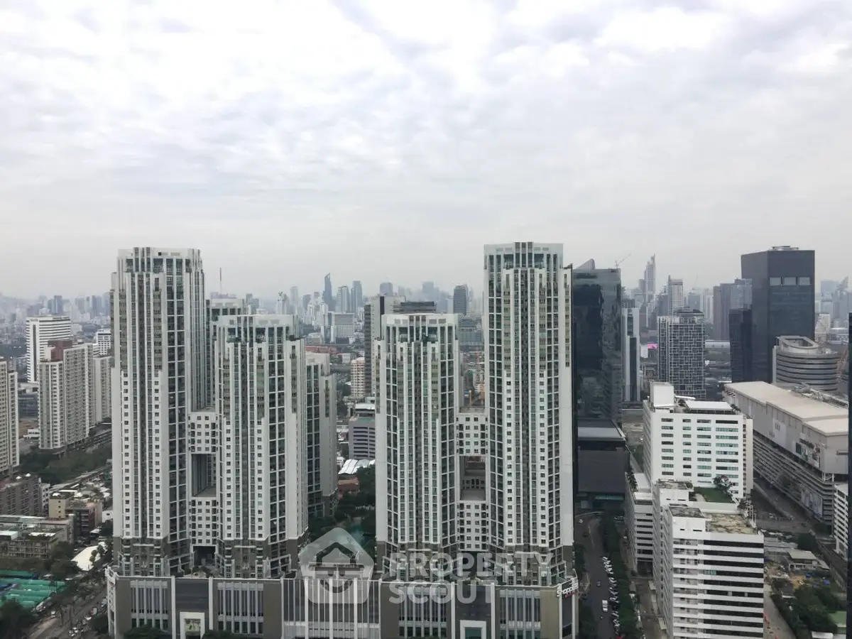 Stunning cityscape view with modern high-rise buildings under a cloudy sky.