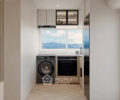 Modern kitchen with mountain view, featuring washing machine and oven, sleek cabinetry, and large window.