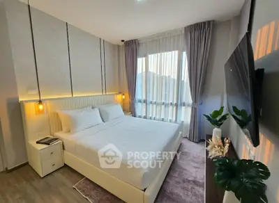 Modern bedroom with elegant decor and large window for natural light