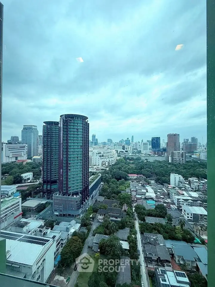 Stunning cityscape view from high-rise building window showcasing urban skyline.