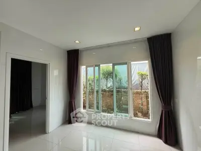Bright room with large windows and garden view, perfect for natural light lovers.
