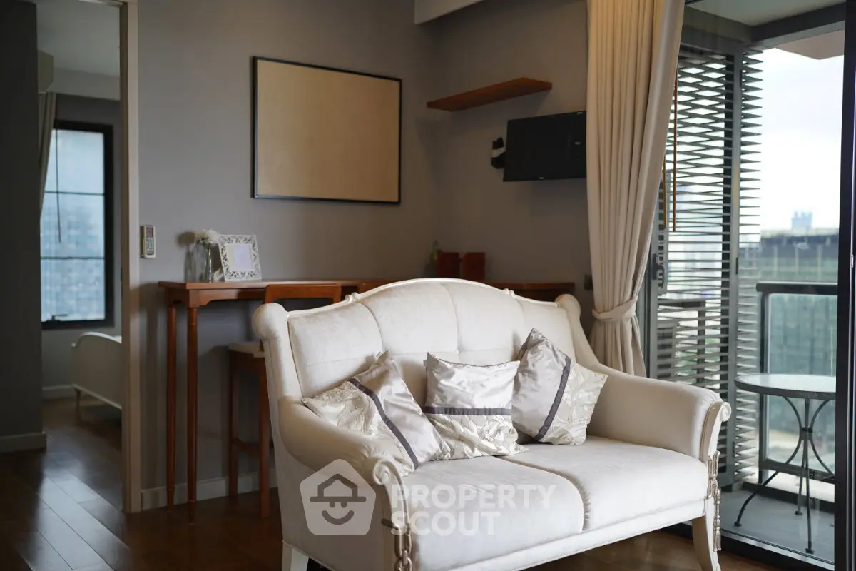 Chic living room with elegant sofa and balcony view in modern apartment