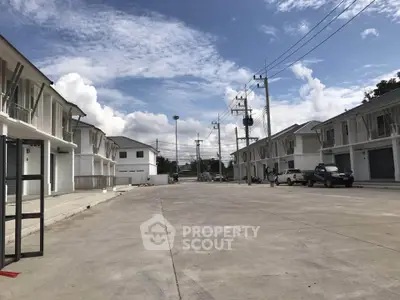 Modern residential complex with spacious driveways and clear blue skies.