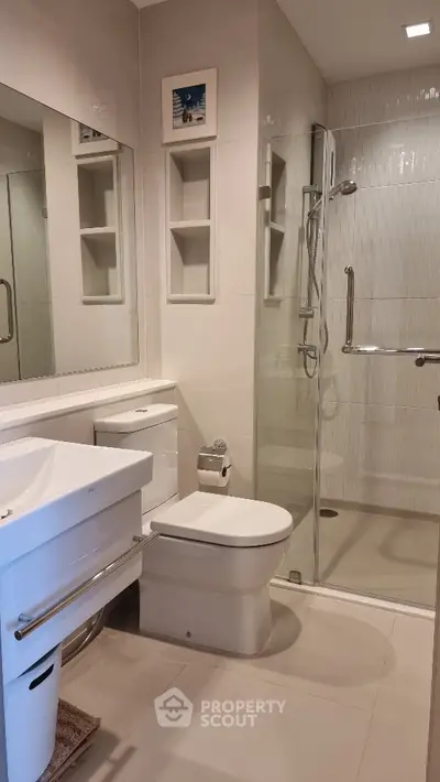 Modern bathroom with glass shower and sleek fixtures