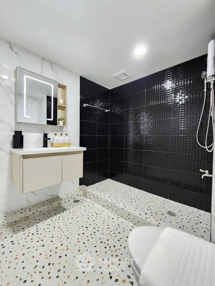 Modern bathroom with sleek black tiles and stylish fixtures