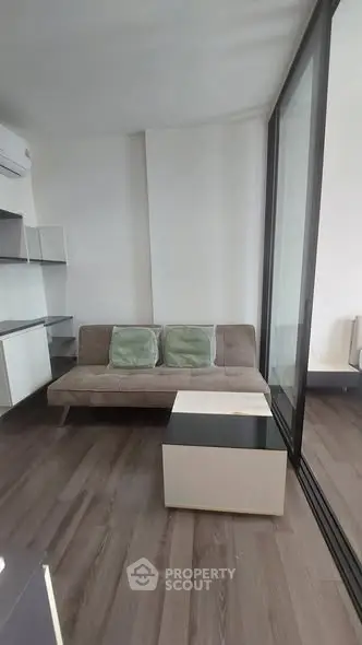 Modern living room with sleek design and glass partition