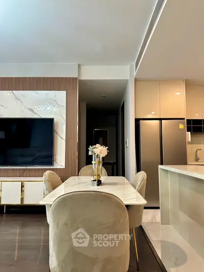 Luxurious modern dining area with elegant marble table and plush chairs in a stylish open-plan living space.