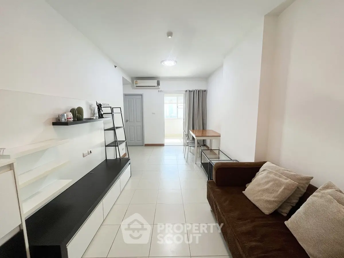 Modern living room with sleek furniture and natural light, perfect for urban living.