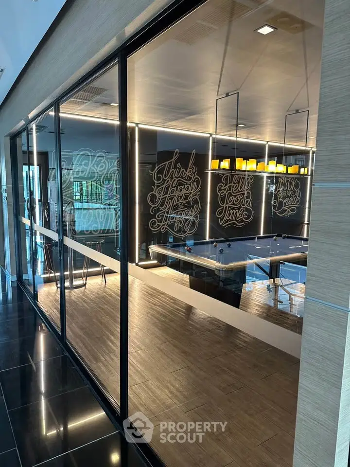 Modern co-working space with glass walls and stylish decor in a commercial building.