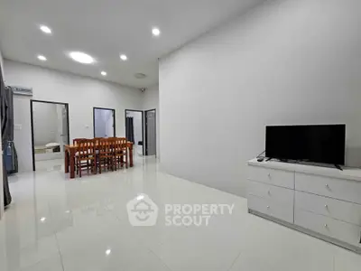 Spacious modern living room with dining area and sleek white flooring