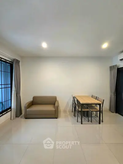 Modern living room with minimalist furniture and dining area