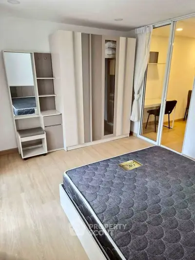 Modern bedroom with stylish wardrobe and comfortable mattress in a bright apartment.