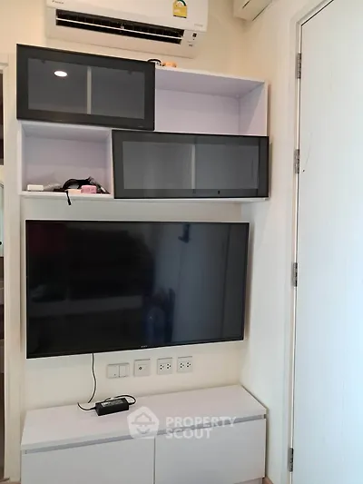 Modern living room with wall-mounted TV and sleek storage cabinets