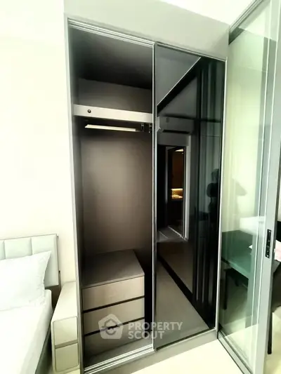 Modern bedroom with sleek built-in wardrobe and sliding glass doors