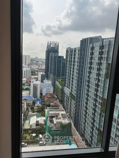 Stunning cityscape view from high-rise apartment window showcasing modern urban living.