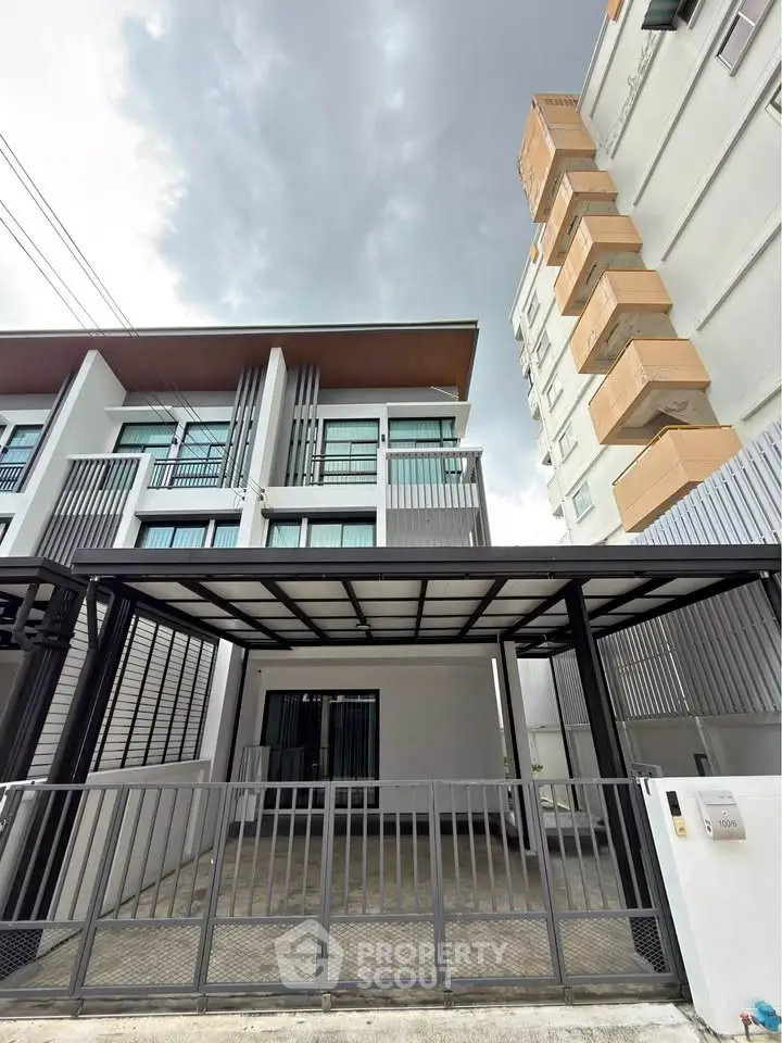 Modern townhouse exterior with sleek design and gated entrance, perfect for urban living.