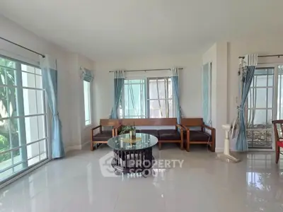 Spacious living room with large windows and elegant furniture