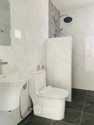 Modern minimalist bathroom with sleek fixtures and marble tiles