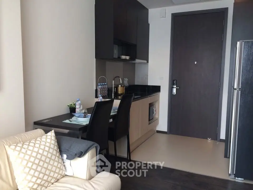 Modern compact kitchen with dining area in stylish apartment