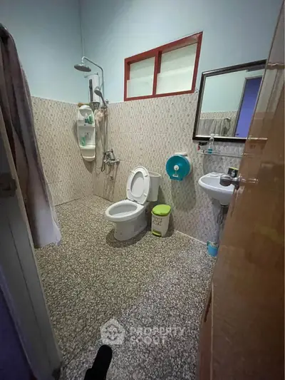 Cozy bathroom with shower and modern fixtures, ideal for compact living spaces.