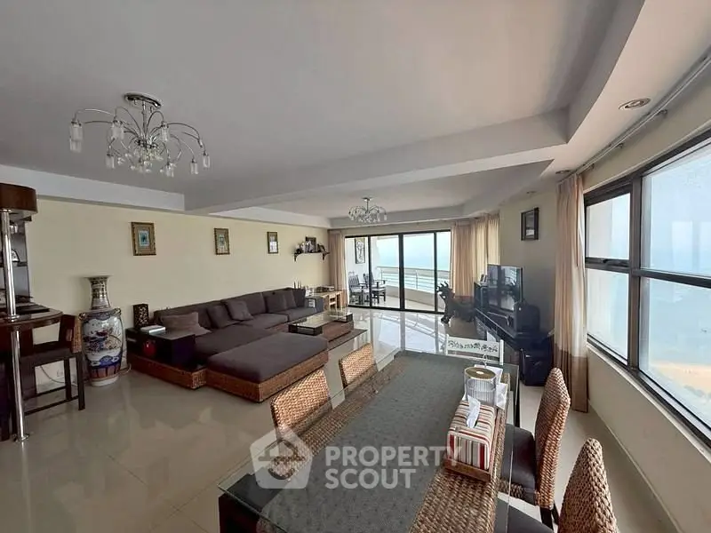 Spacious living room with ocean view, modern furniture, and large windows for natural light.