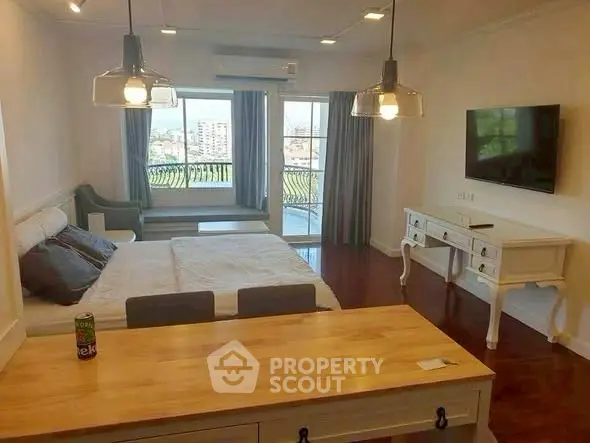 Spacious bedroom with balcony view and elegant furnishings