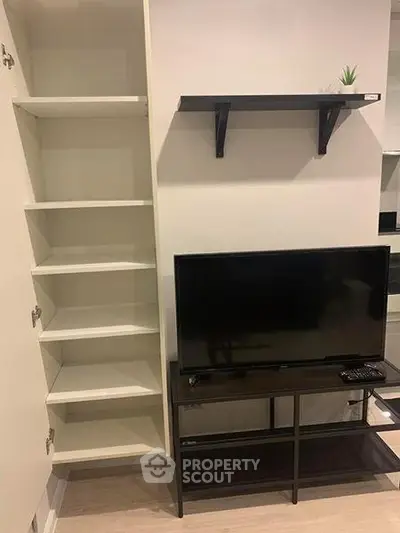 Modern living room with sleek TV stand and open shelving unit