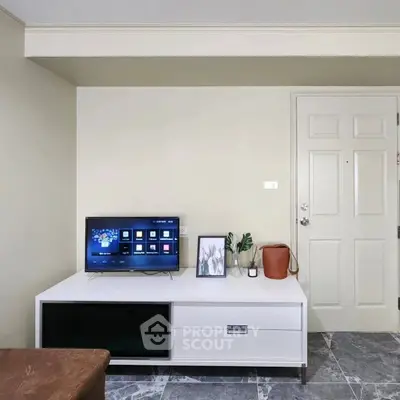 Modern living room with sleek TV stand and marble flooring