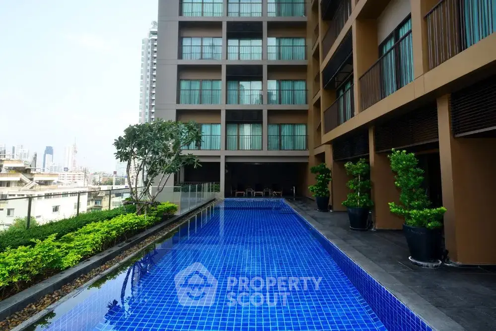 Luxurious apartment building with stunning rooftop pool and city views.