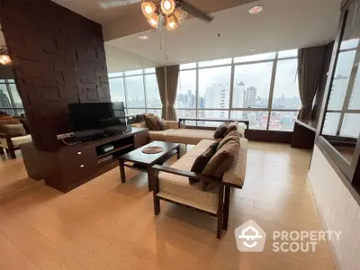 Spacious modern living room with panoramic city views and elegant wooden flooring.