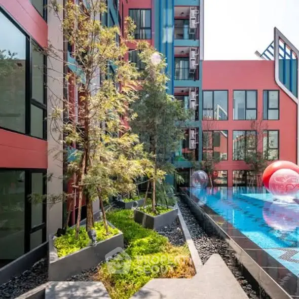 Modern apartment building with stylish pool and vibrant exterior design.