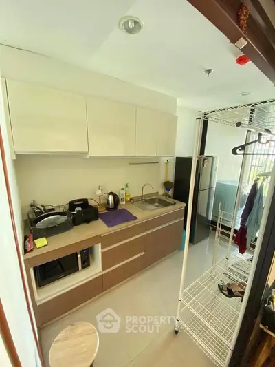 Compact kitchen with modern appliances and open layout in urban apartment