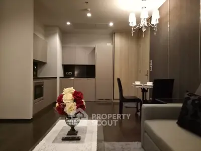 Elegant modern living room with open kitchen and stylish chandelier
